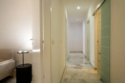 a hallway with a couch and a room with a corridor at The Right Place 4U Piemonte Apartment in Rome