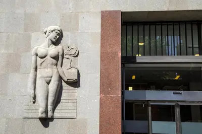 a statue of a woman on the side of a building at The Right Place 4U Piemonte Apartment in Rome