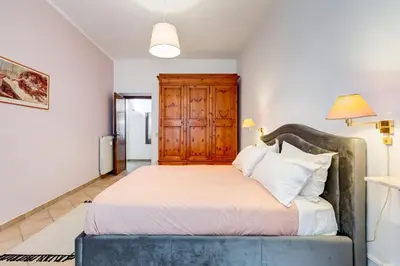a bedroom with a large bed with a wooden headboard at Apartment Atelier Testaccio in Rome