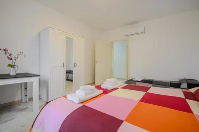 a bedroom with a colorful bed with towels on it at Ponte Milvio Apartment Flaminio in Rome