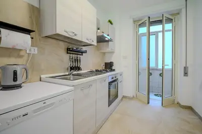 a white kitchen with a sink and a stove at Ponte Milvio Apartment Flaminio in Rome