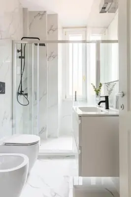 a white bathroom with a shower and a toilet and a sink at SJR Luxury Apartment Trevi Fountain in Rome