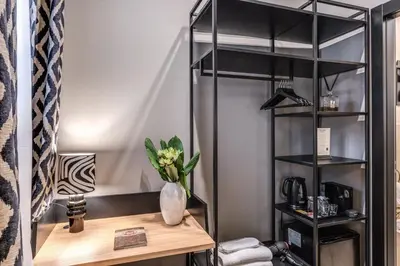 a shelf with a vase of flowers on a desk at Telier Belsiana in Rome