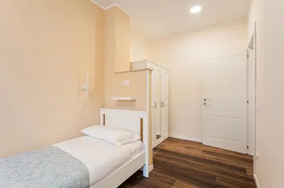 a small bedroom with a bed and a closet at Prati Grabau Comfort 3 rooms apt in Rome
