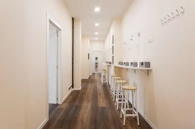 a row of stools in a bar in a salon at Prati Grabau Comfort 3 rooms apt in Rome