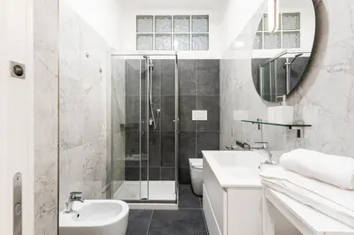 a bathroom with a shower and a sink and a toilet at Prati Grabau Comfort 3 rooms apt in Rome