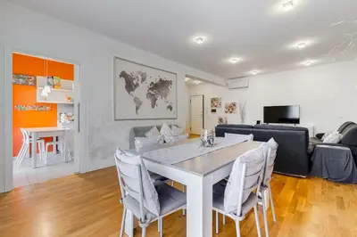a dining room and living room with a table and chairs at Valle Aurelia Vatican Home - Beutiful View & Wi-Fi in Rome