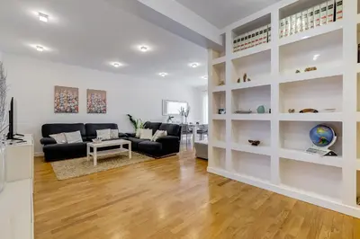 a living room with white walls and wooden floors at Valle Aurelia Vatican Home - Beutiful View & Wi-Fi in Rome