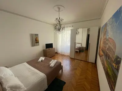 a bedroom with a bed and a chandelier at Morosini House Rome in Rome