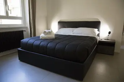 a bedroom with a large bed with two stuffed animals on it at Appartamento Roman Feelings in Rome