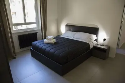 a bedroom with a bed with a towel on it at Appartamento Roman Feelings in Rome