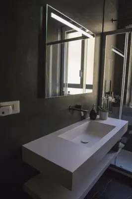 a bathroom with a white sink and a mirror at Appartamento Roman Feelings in Rome