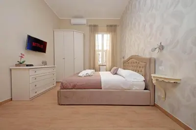 a bedroom with a bed and a dresser in it at Julius House in Rome