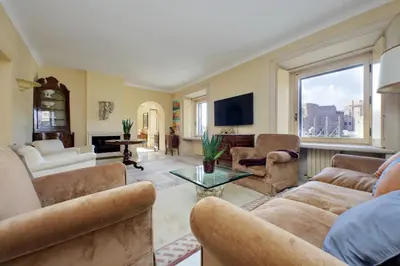 a living room filled with furniture and a large window at Colosseo Way in Rome