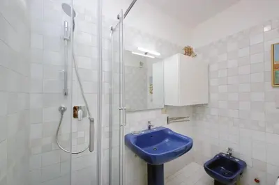 a bathroom with a blue sink and a shower at Colosseo Way in Rome