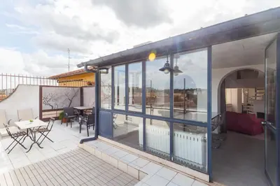 a balcony with glass doors and a table and chairs at Prati Belfiore Guesthouse in Rome