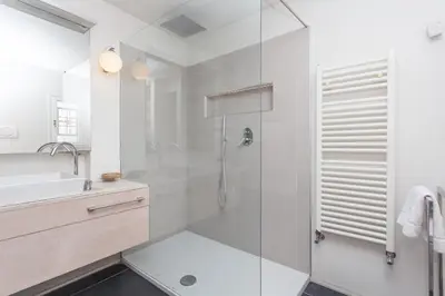 a white bathroom with a shower and a sink at Prati Belfiore Guesthouse in Rome