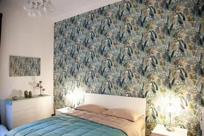 a bedroom with a blue bed and a wall mural at Three sisters- La casa nel Cuore di Roma in Rome