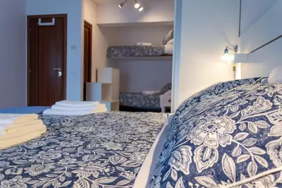 a bedroom with a bed with a blue and white bedspread at TESTACCIO XIX-XXV Bed & Breakfast in Rome