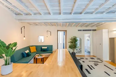 a living room with a long table and a couch at Cantoni 4A - Loft at Colosseum in Rome