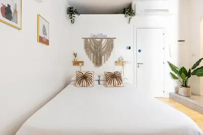 a bedroom with a large white bed with two pillows at Cantoni 4B - Studio at Colosseum in Rome