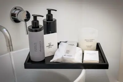 a shelf with two bottles of soap and other products at Cantoni 4B - Studio at Colosseum in Rome