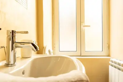 a bathroom with a toilet and a sink at SorinaHome Campo de Fiori Apartament in Rome