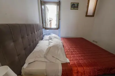 a bed in a room with a red carpet at Campo de Fiori Large Family Apartment in Rome