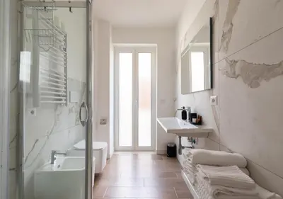 a bathroom with a shower and a sink and a toilet at Vatican family loft in Rome