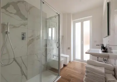 a bathroom with a shower and a toilet and a sink at Vatican family loft in Rome