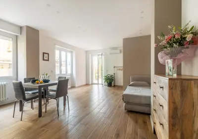 a living room with a table and chairs and a couch at Vatican family loft in Rome