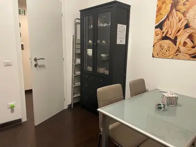 a dining room with a table and a black cabinet at Aniene GH in Rome