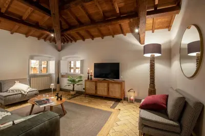 a living room with a couch and a tv at Maison Medusa in Rome