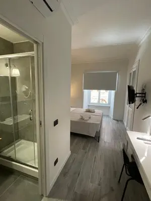 a room with a glass door leading to a bedroom at This must be the place Rome Guesthouse in Rome