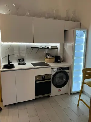 a kitchen with a stove and a washing machine at Loft a piazza di Spagna in Rome