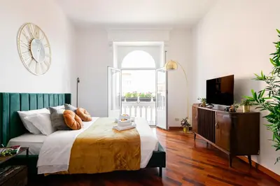 a bedroom with a large bed and a television at Piacentino Homes San Giovanni apartment in Rome