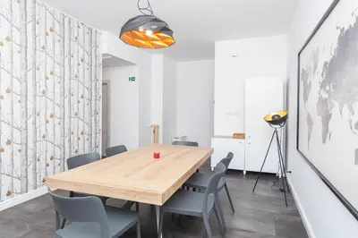 a dining room with a wooden table and chairs at Fiorini - Rooms in Rome