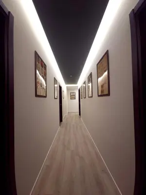 a long hallway with paintings on the walls at Piol Guest House in Rome