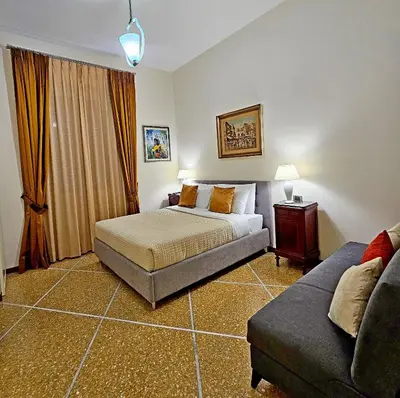 a bedroom with a bed and a couch at Vatican Prestige - Meospiti Cesare Exclusive in Rome