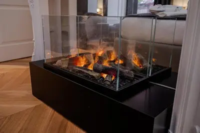 a fireplace in a living room with flames in it at Acque Romane Piazza di Spagna in Rome