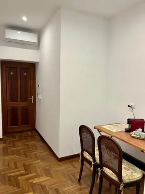 a room with two chairs and a table and a door at Domus Giovanna in Rome