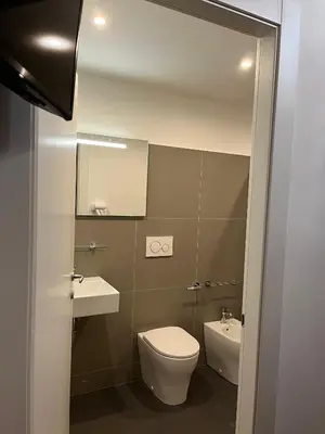 a bathroom with a toilet and a sink and a mirror at Domus Giovanna in Rome