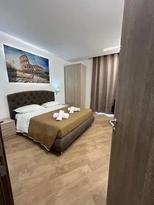 a bedroom with a bed with two towels on it at Grimaldi Comfort Guest House in Rome