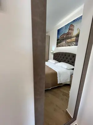 a bedroom with a bed and a painting on the wall at Grimaldi Comfort Guest House in Rome