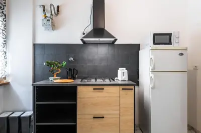 a kitchen with a white refrigerator and a stove at Gianicolense Apartment in Rome