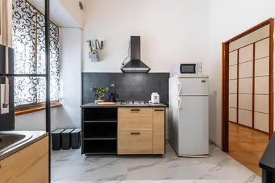 a kitchen with a white refrigerator and a stove at Gianicolense Apartment in Rome