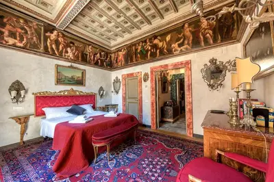 a bedroom with a bed and a painting on the walls at Piazza Navona historical palace in Rome