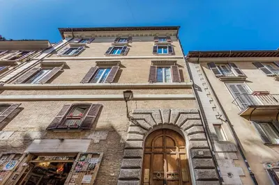 a tall building with a door and a window at Piazza Navona historical palace in Rome