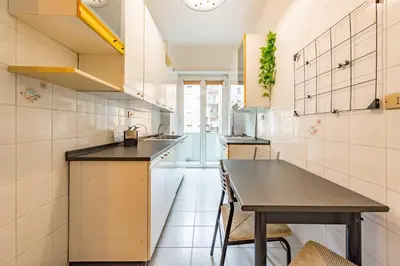 a living room with a blue couch and a tv at Iolanda Fine & Spacious Flat in Rome
