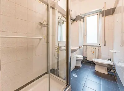 a bedroom with a bed and a desk and a television at Iolanda Fine & Spacious Flat in Rome
